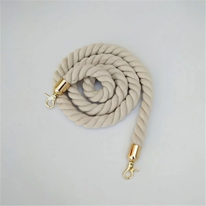 Detail of beige cotton braided strap with golden metal swivel hooks on white background