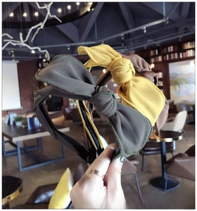 Detailed close-up of colorful fabric bow headbands in olive green, yellow, and brown tones