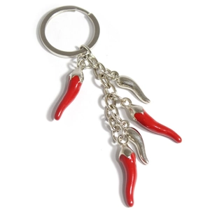 Macro view of five red and silver chili pendants on a polished metal keychain