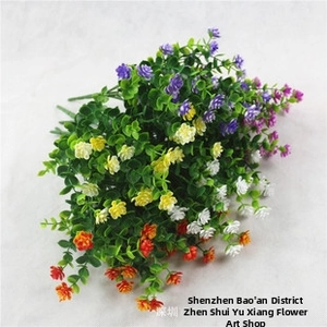 Detailed view of colorful artificial eucalyptus with purple, yellow, and white floral clusters