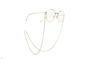 Detail of elegant gold snake chain attached to slim metal frame glasses for DIY accessory