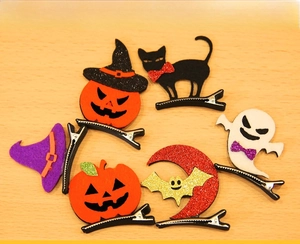 Flat lay of colorful Halloween felt hair clips with pumpkin, ghost and bat designs