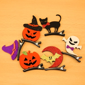 Halloween hair clips set with pumpkin, ghost, and bat felt designs on wood background