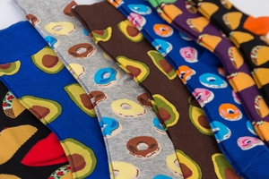 Detail showing various cotton socks with colorful avocado and donut food patterns