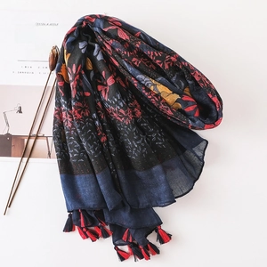 Floral cotton linen scarf with vintage prints and red tassel trim on a white background