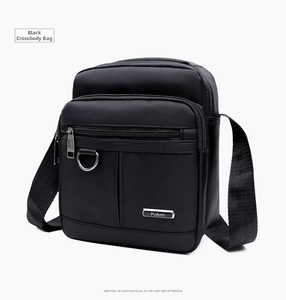Detail view of black Oxford cloth crossbody bag with metallic logo and adjustable strap