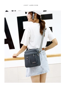 Close-up of waterproof Oxford fabric crossbody bag with multi-layer zippers and adjustable strap