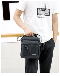 Model showing a black waterproof Oxford cloth crossbody bag with multiple zip pockets