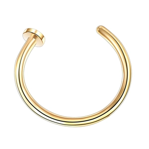 Detail of golden stainless steel C-shaped nose ring with polished finish on white background