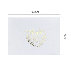 White gold-stamped Thank You greeting card with leaf design and white envelope