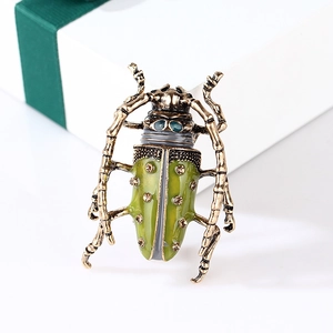 Detailed view of vintage grasshopper brooch with green enamel and sparkling rhinestones