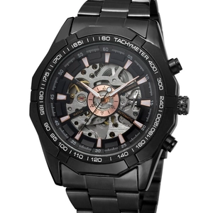 Macro shot of black skeleton mechanical watch with rose gold indices and tachymeter