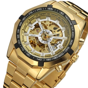 Detailed close-up of golden skeleton dial and automatic mechanical movement on men's watch