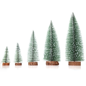 Five miniature snowy pine Christmas trees with natural round wooden bases on white background