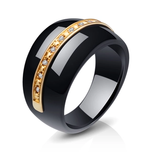 Minimalist black ceramic ring with gold plating and paved crystals in a 45-degree view