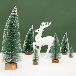 White flocked reindeer with green snow-covered Christmas trees on wooden base decor