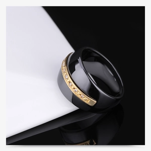 Macro shot of a 14mm black ceramic and gold stainless steel ring with micro-set stones
