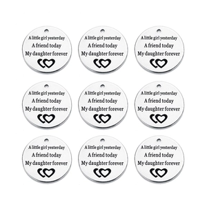 Detailed view of nine engraved silver stainless steel charms with daughter quote