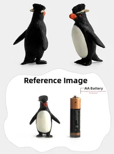 Detail view of rockhopper penguin toy model with yellow feathers next to a battery for scale