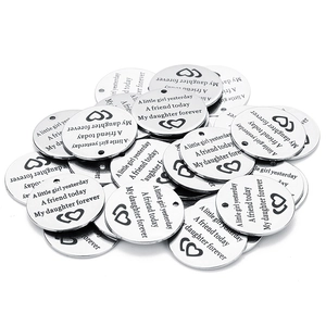Close-up of engraved stainless steel round tags for DIY necklace jewelry making