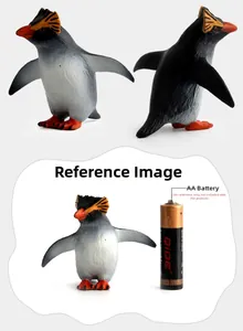 Detailed views of a realistic emperor penguin toy model next to a scale battery