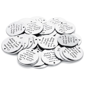 Close-up of bulk silver round stainless steel charms with I'll always be your little girl engraving