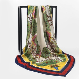 Detail view of large floral satin scarf with landscape print hanging on a black frame