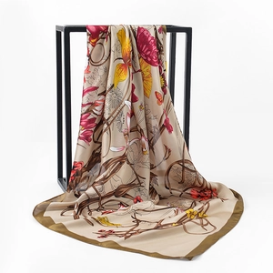 Detail of silk-satin floral square scarf with olive green border on a black metal stand