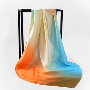 Detailed view of elegant gradient orange and blue silk scarf with fine rolled edges