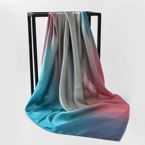 Detailed view of large floral satin silk scarf with blue, silver, and pink gradient texture