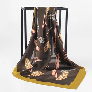 Detailed macro view of feather printed silk scarf fabric with elegant satin gloss texture