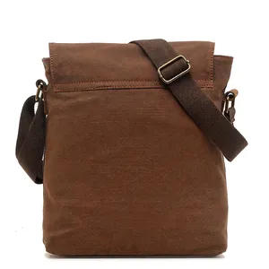 Vintage brown canvas crossbody bag with adjustable shoulder strap and retro brass buckles
