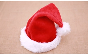 Close-up of plush red Santa hat with soft white faux fur trim and fluffy pompom detail