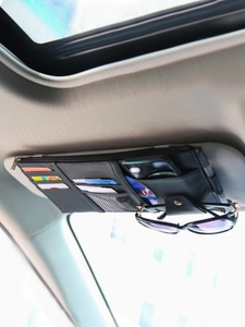 Detailed view of black PU leather car sun visor organizer with cards and sunglasses