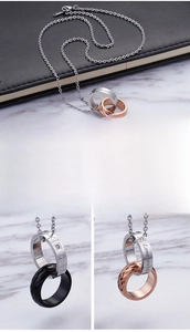 Detailed view of interlocking titanium steel rings with diamond setting and Love engraving