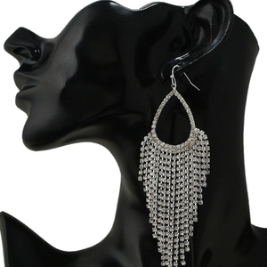 Detail of silver teardrop tassel earrings with sparkling rhinestones on a black mannequin