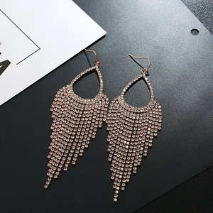 Detailed view of rose gold teardrop tassel earrings with sparkling rhinestones