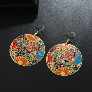 Detailed view of colorful bohemian floral drop earrings with gold metallic hooks