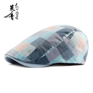 Detail of classic plaid newsboy cap showing blue grey check texture and striped brim lining