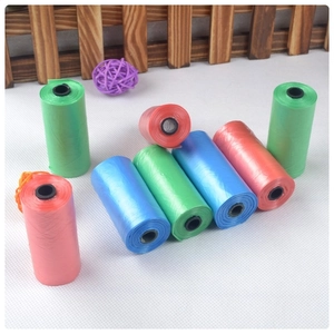 Detail of colorful biodegradable pet waste bag rolls in red, blue and green colors