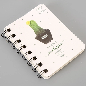 Close-up of A7 spiral notebook featuring green cactus cover design and black wire binding