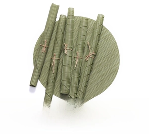 Close-up of grass green woven round PVC placemat with bamboo texture and rollable set