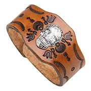 Detailed view of brown leather wide wristband with silver skull and embossed patterns
