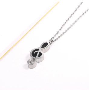 Macro detail of silver treble clef perfume bottle pendant for ashes on O-chain necklace