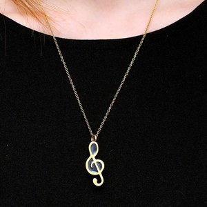 Elegant gold musical note perfume bottle necklace pendant worn on a female model