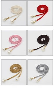 Detail view of woven waist ropes in six colors featuring elegant large pearl pendants