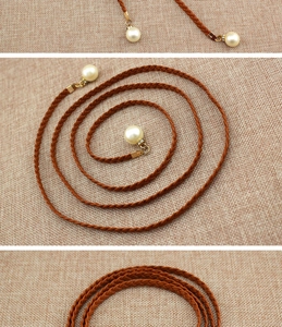 Close-up of brown woven rope belt with large faux pearls and gold metal accents
