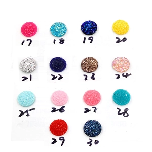 Flat lay of colorful resin druzy charms with numeric markers for DIY jewelry making