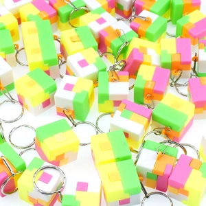 Pile of colorful mini puzzle cube keychains for brain teasing and party favors