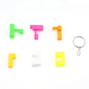 Disassembled parts of a colorful 3D geometric puzzle keychain with a metal ring